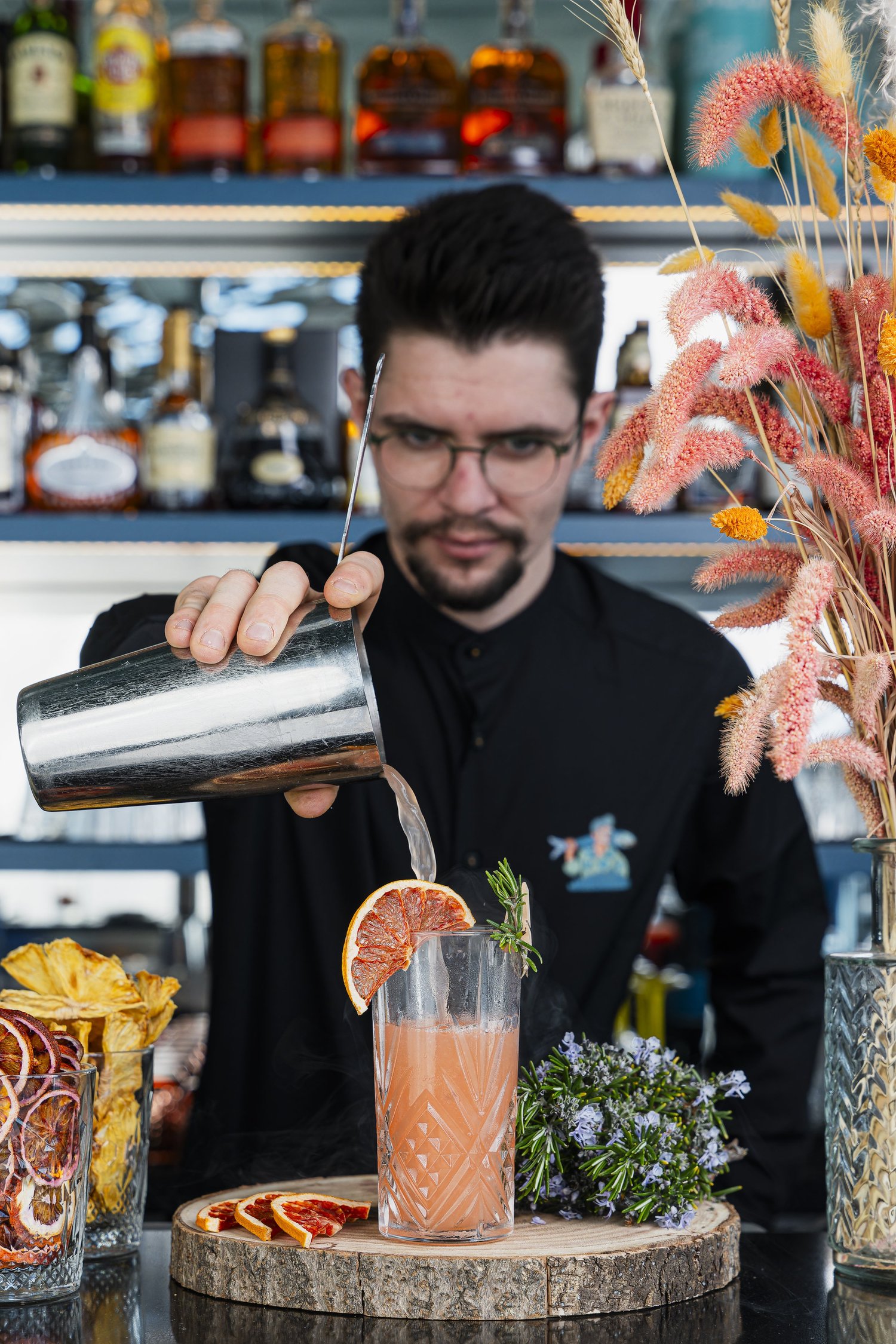 Le barman verse un cocktail au pamplemousse derrière son bar, hôtel Nhow, Marseille