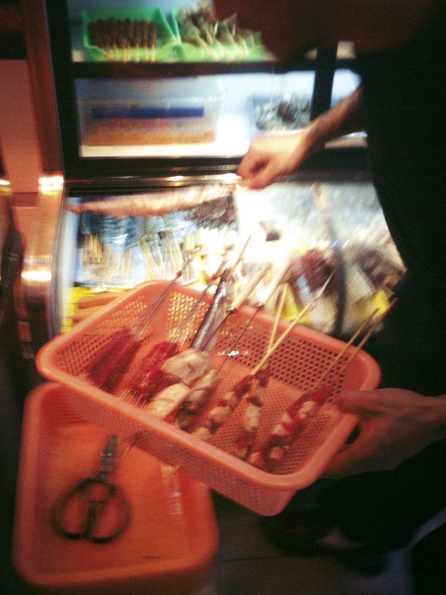Panier de brochettes crues choisies au comptoir d'une échoppe de rue, le soir, Shanghai