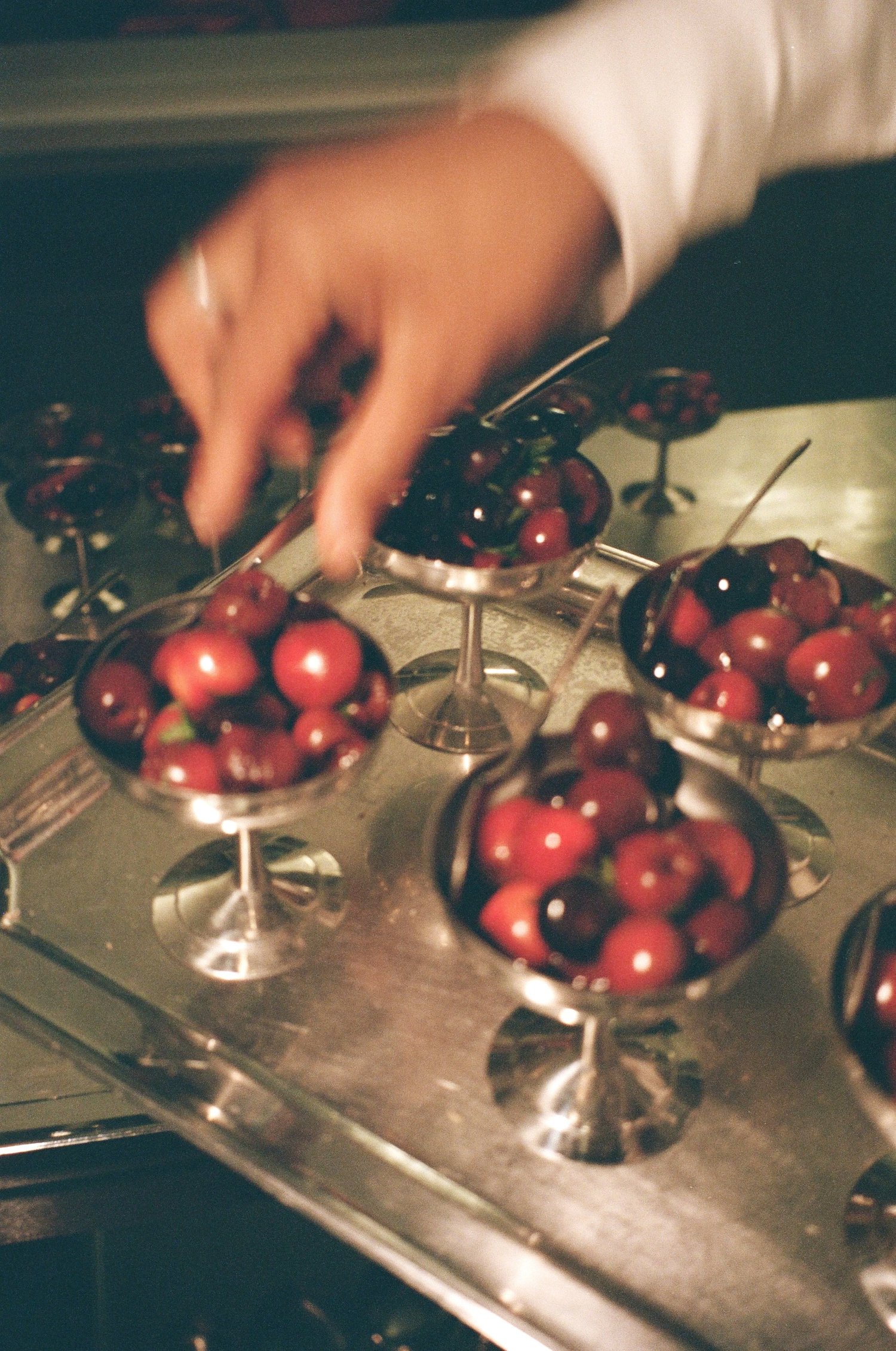 Coupes d'argent remplies de cerises, dessert du dîner Chanel signé Valentin Raffali